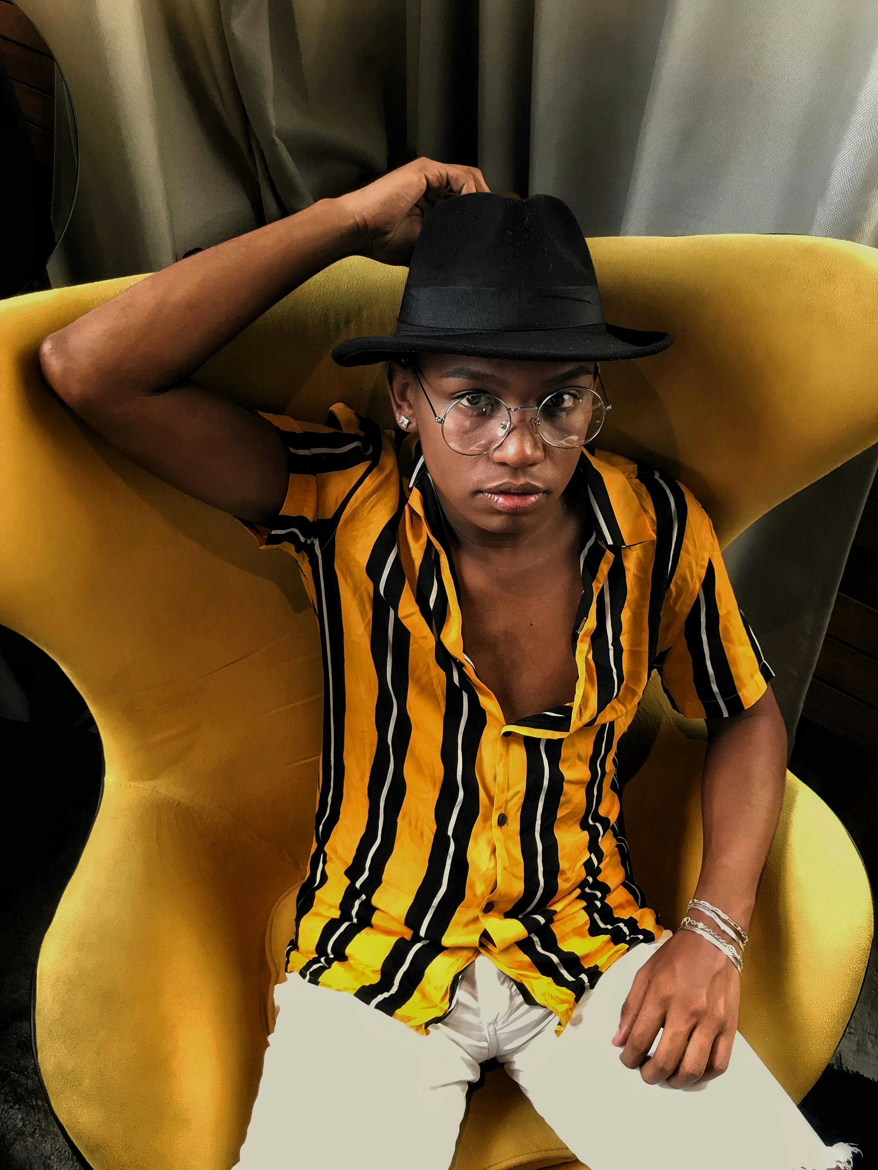 Man Wearing Mask Sitting Down and Holding Newspaper With ...