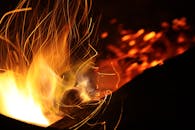 在夜间，动态火焰和火花的长曝光镜头营造出温暖的氛围