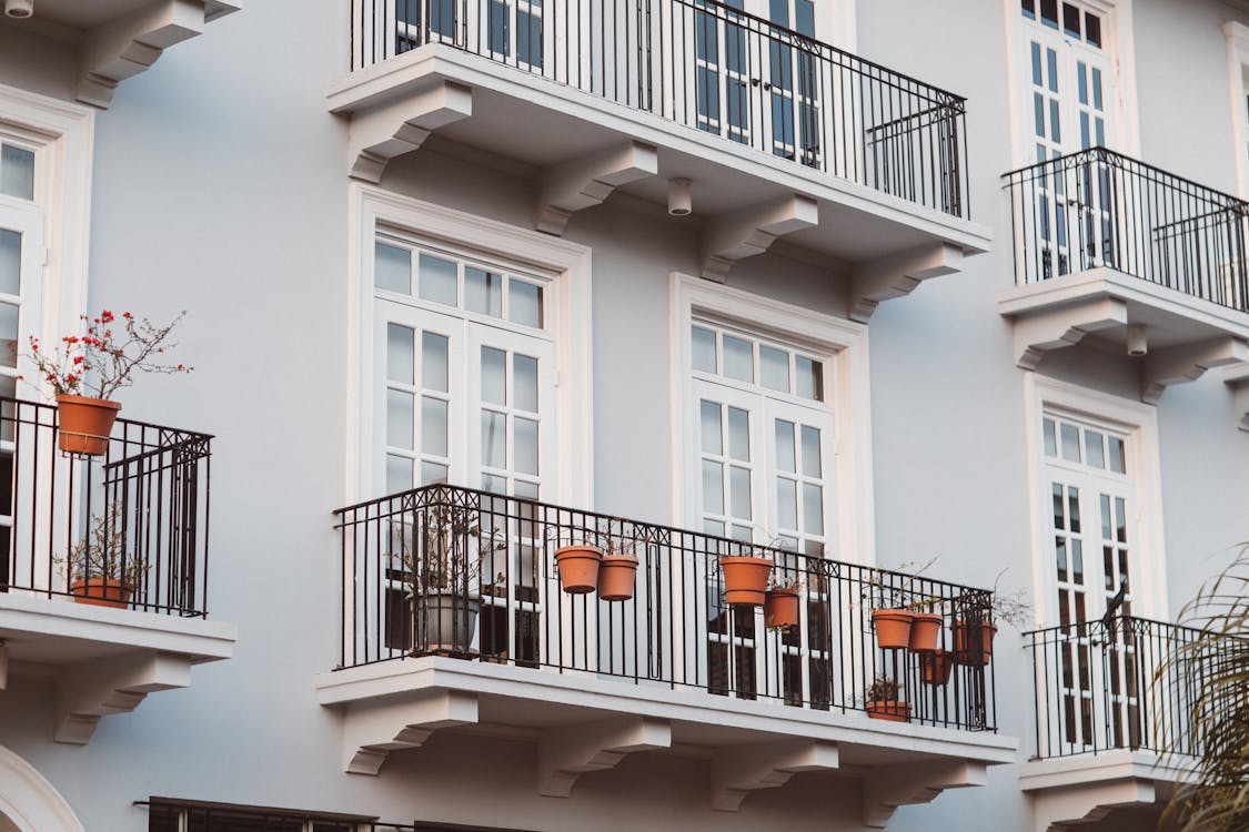 Free White Concrete Building With Black Metal Railings Stock Photo