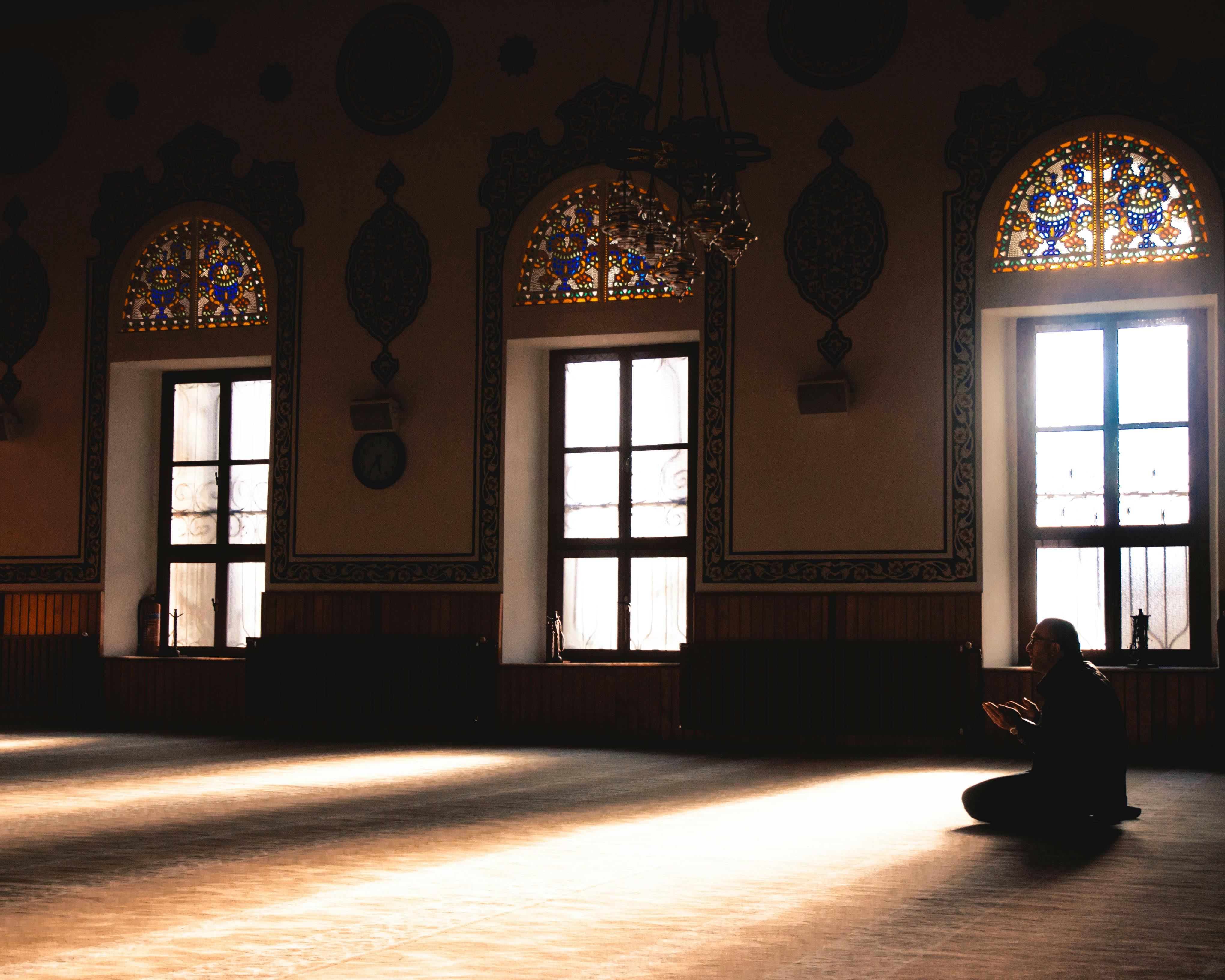A guy praying inside the mosque 