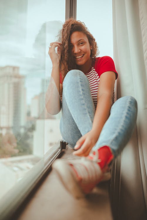 Woman Sitting Beside Window