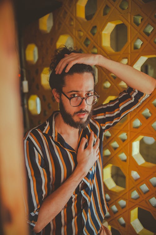 Free Man Wearing Black and Brown Button-up Shirt in Room Stock Photo