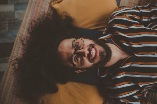 Man Lying on Bed Smiling