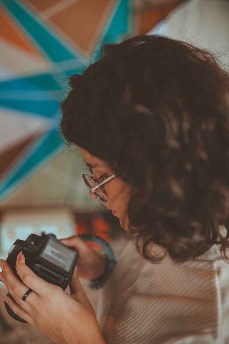 Woman Looking At Dslr Camera