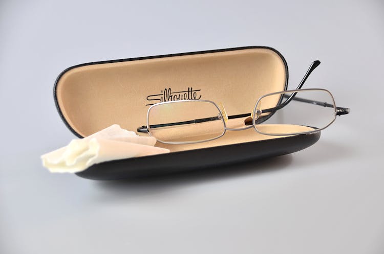 Silver Framed Eyeglasses On Black Eyewear Case