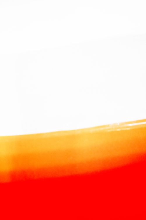Free A vivid abstract image capturing a gradient of red and orange hues against a white background. Stock Photo