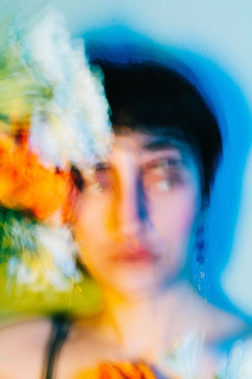 A woman with flowers in her hair and a blurry background