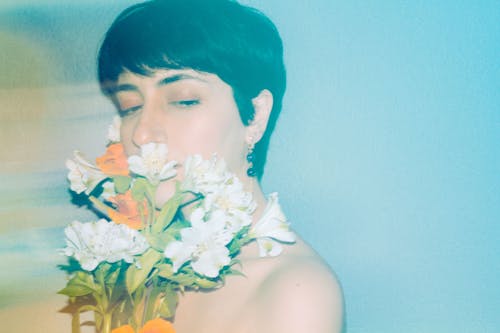 A woman with flowers in her hair and a blue background