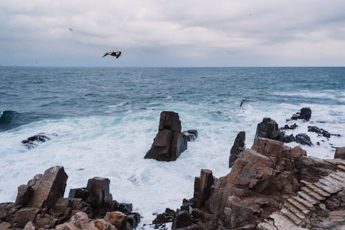 Wavy Sea Crashing Through Rock Formations