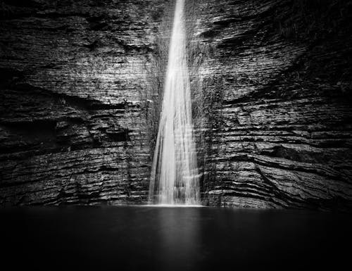 Black and white photograph of a waterfall in the woods