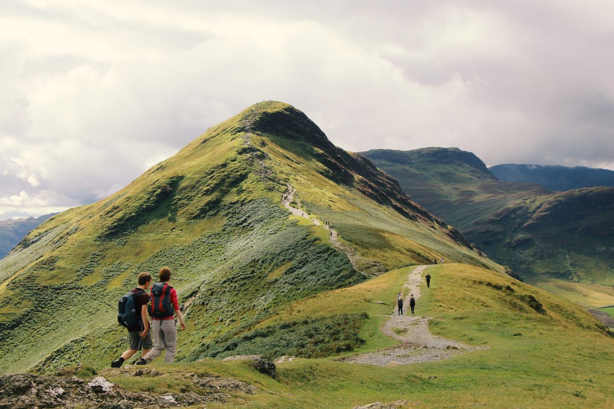Walkers following the ridge path towards Catbells in the Lake District.