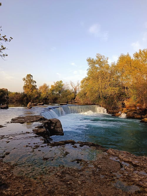 A waterfall in the middle of a river