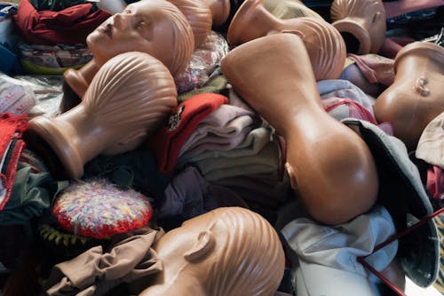 Free A pile of mannequins and clothes in a room Stock Photo