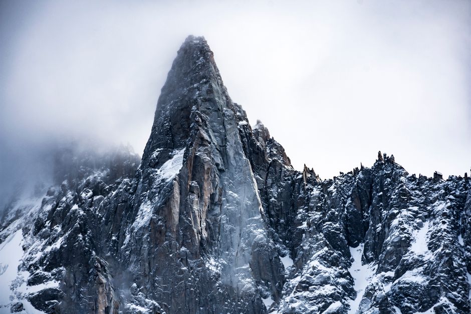 Breathtaking view of snow-covered mountains in Chamonix, France on a foggy winter day.