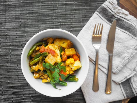 A delicious bowl of vegetable curry topped with fresh cilantro, perfect for a healthy meal.