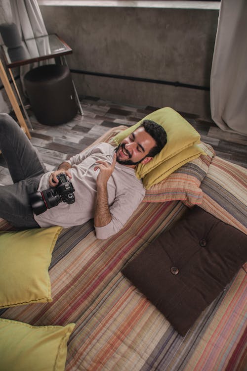 Free Smiling Man Lying On Mattress Stock Photo