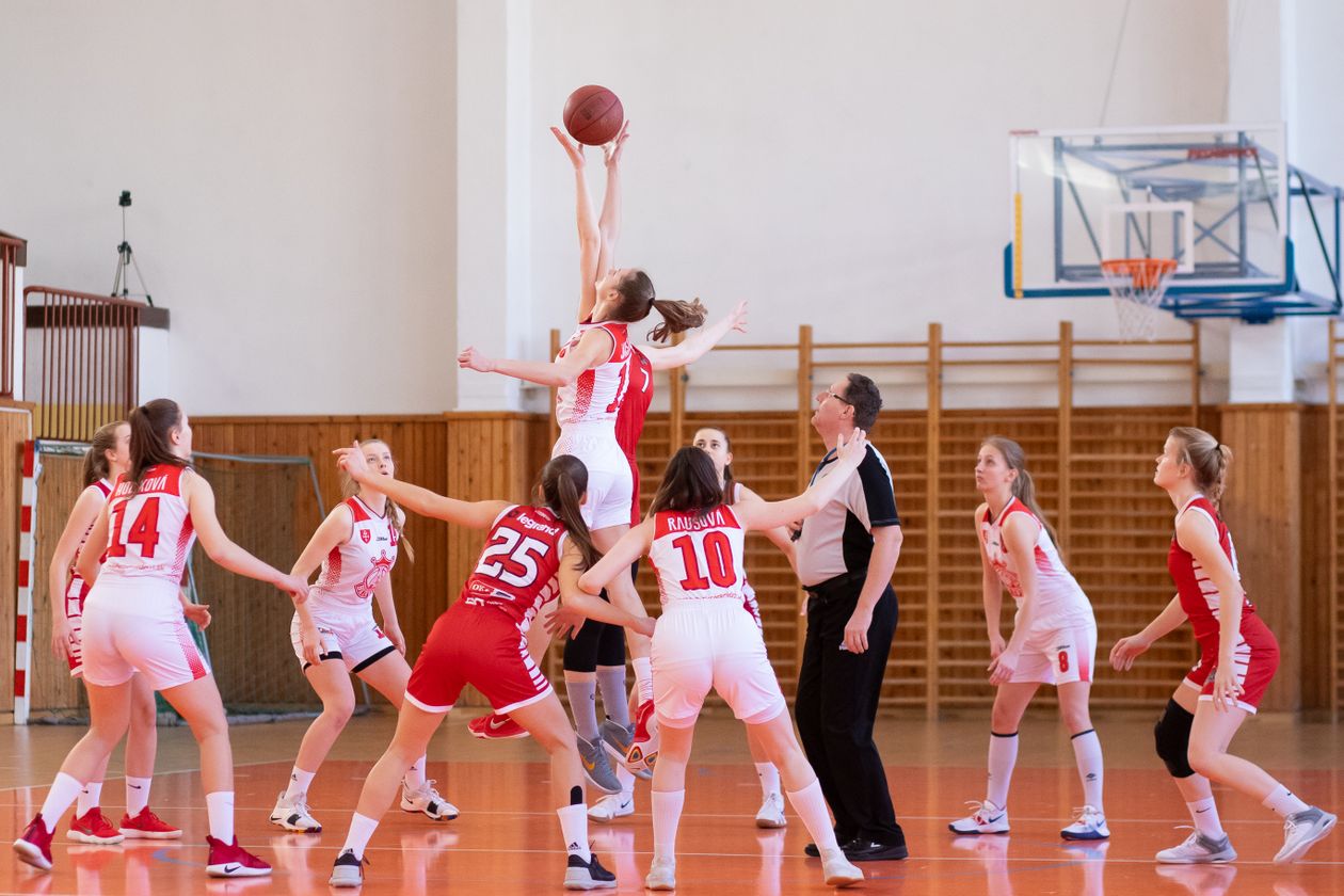 Women competing in basketball game