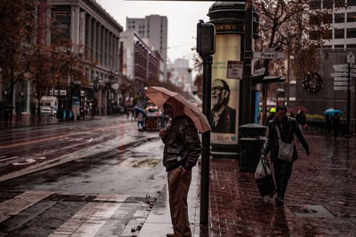 Free A rainy day in San Francisco with people walking along Powell Street holding umbrellas. Stock Photo