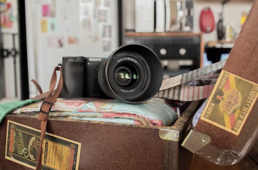 一台带镜头的现代相机被放在老式手提箱上，手提箱位于舒适的室内环境中