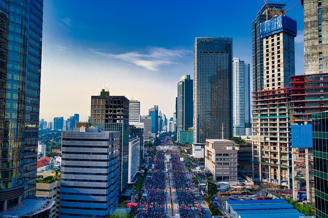 Free Stunning aerial view of Jakarta's modern skyline with bustling streets below. Stock Photo