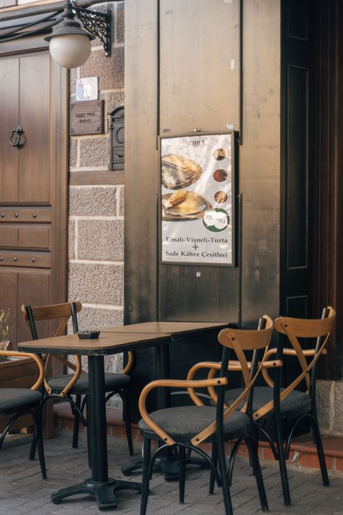 Free An inviting and stylish outdoor seating area of a café in an urban setting, perfect for relaxation. Stock Photo