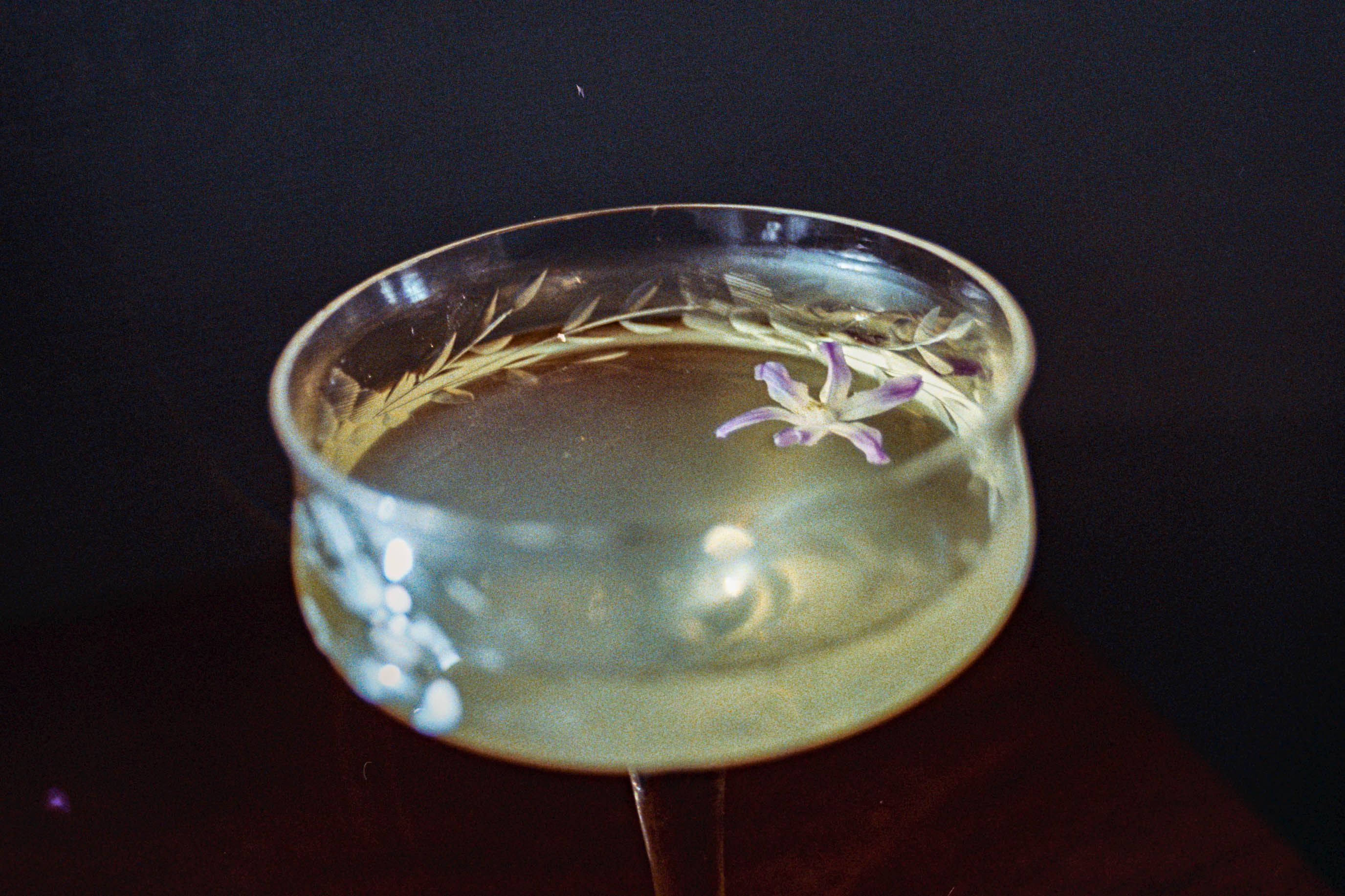 Craft cocktail glass close up against dark background with elegant presentation