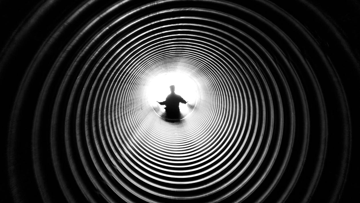 Free Grayscale Photography of Person at the End of Tunnel Stock Photo