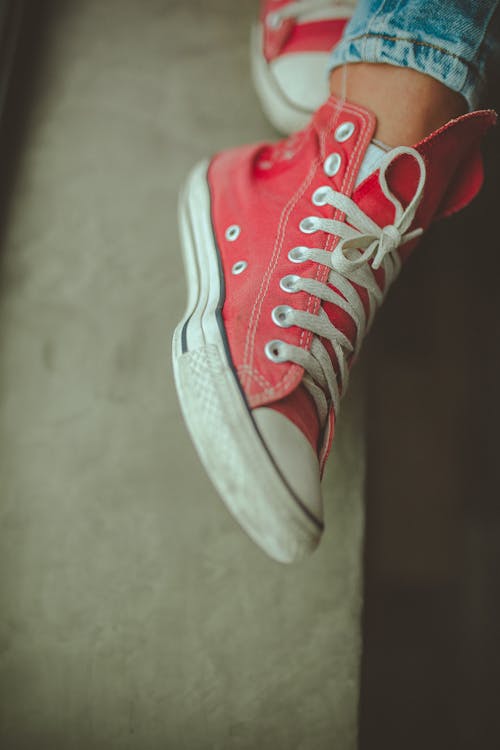 Close-Up Photo of Person Wearing Red Shoe