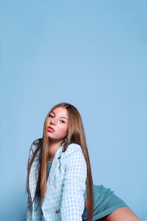 Free A woman in a blue shirt and plaid skirt Stock Photo