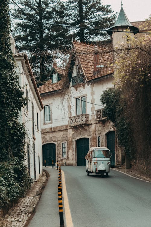 Small car  riding down a country side road