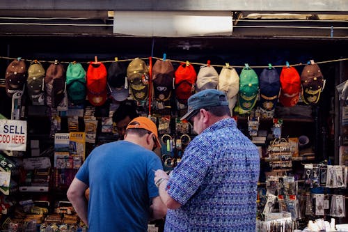 Two people with hats at a souvenir shop