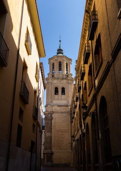 A beautiful church tower seen from a narrow street in Zaragoza, Spain. Architectural elegance.
