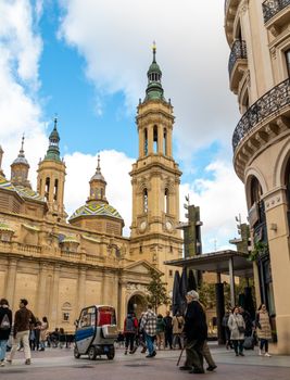 A bustling urban scene in Zaragoza featuring the Basilica of Our Lady of the Pillar.