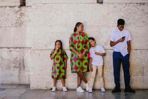 Free Family Waiting by a Wall Stock Photo