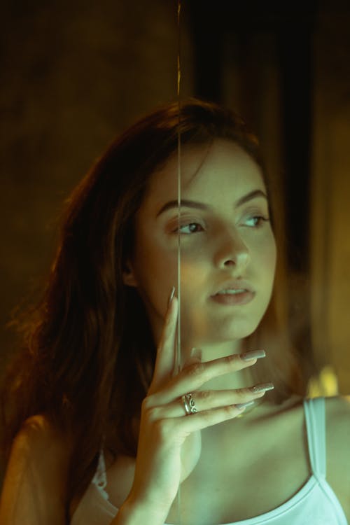 Photo of Woman Holding On Glass