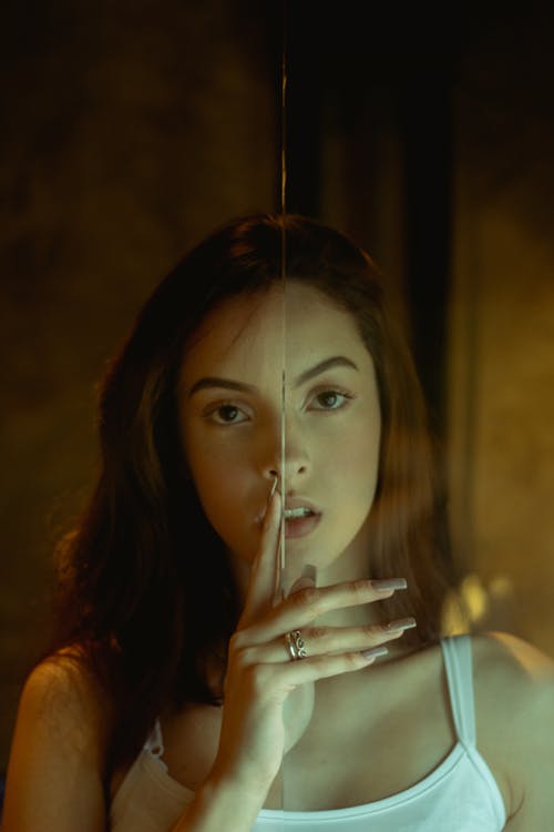 Photo of Woman Holding On Glass