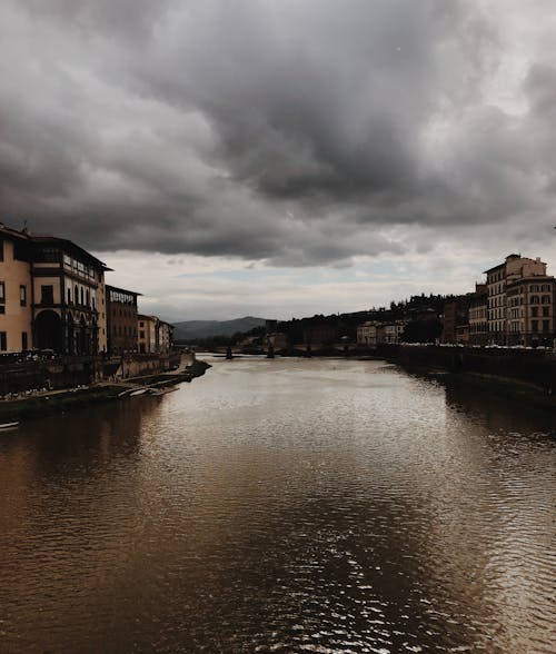 River Between Houses Under Dramatic Sky