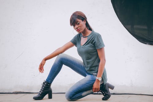 Woman In A T-shirt Sitting On Ground