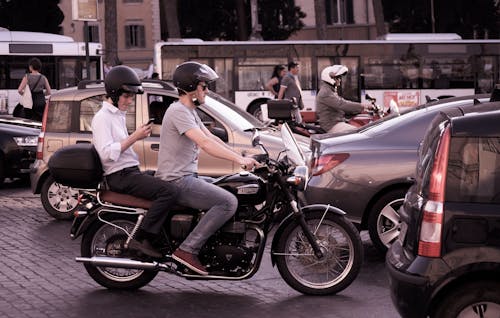 Two Person Riding Motorcycle Beside Vehicles