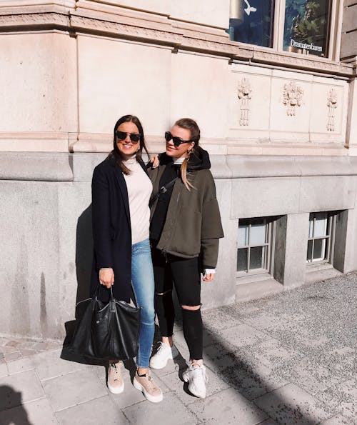 Photo of Women Smiling and Wearing Shades