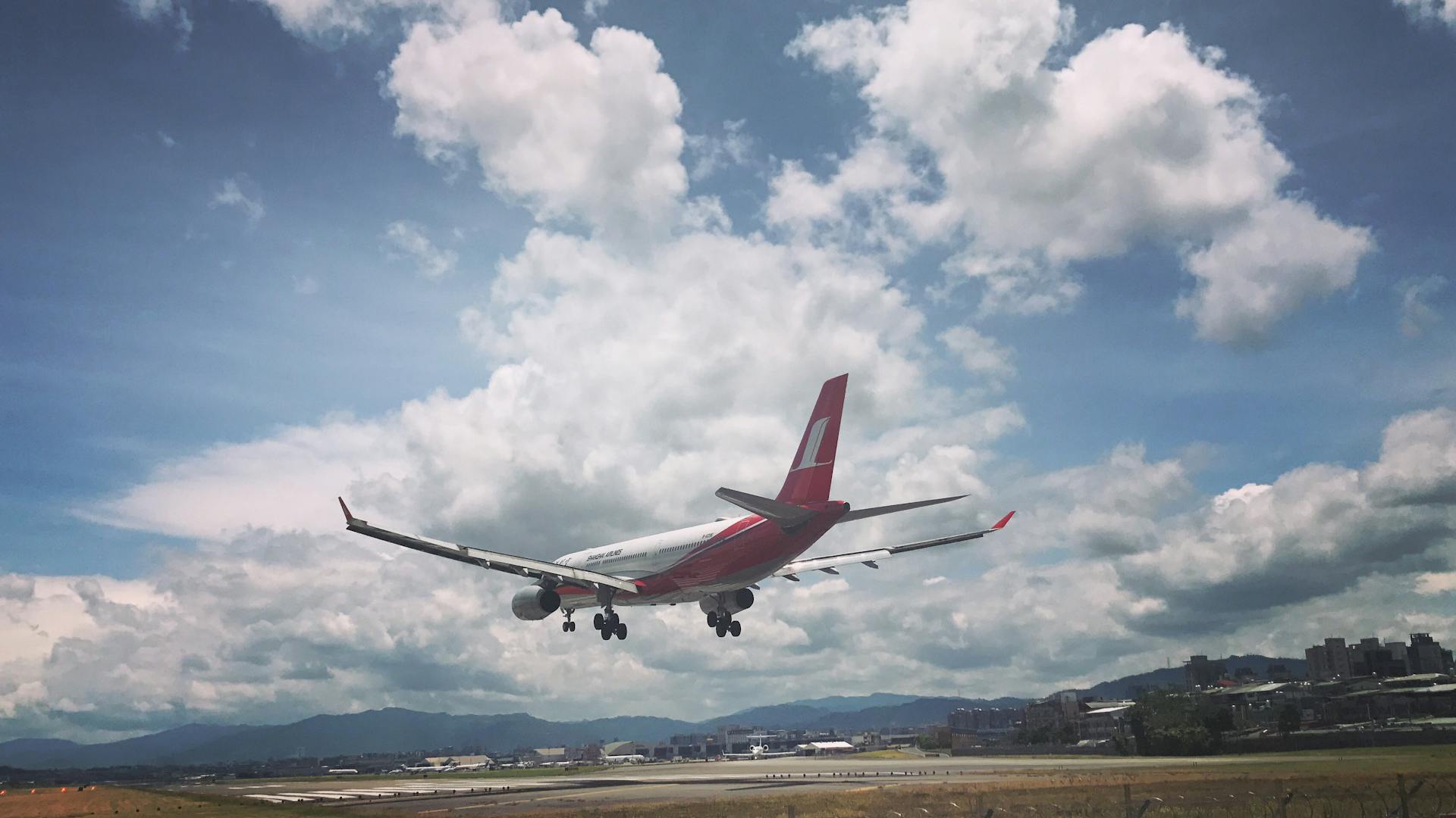 Photo of Airplane Over Runway