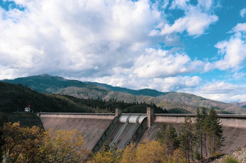 A large dam with mountains in the background