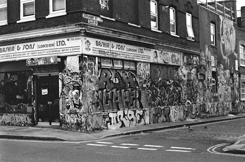 A black and white photo of a building with graffiti on it