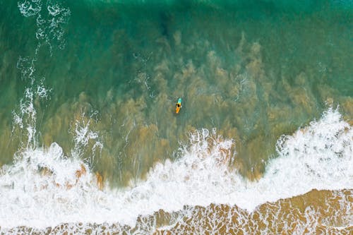 Free Aerial view of surfer in the ocean Stock Photo