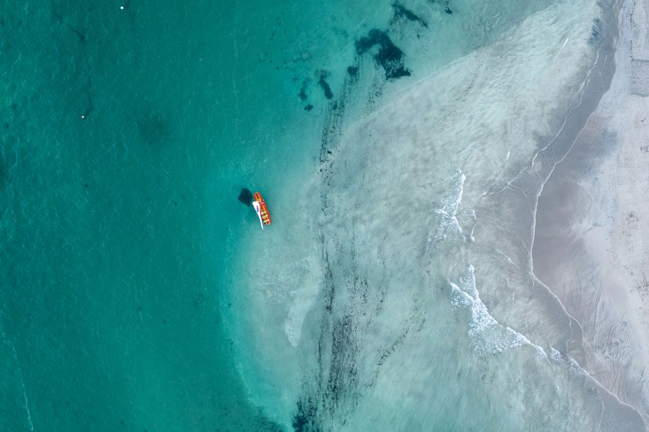 beach nosy be turquoise water sailboat