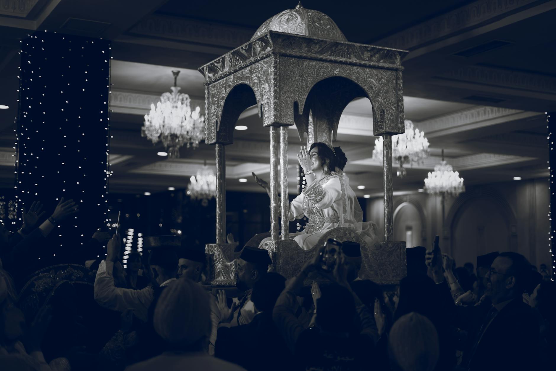Elegant indoor Moroccan wedding with bride carried in canopy at Casablanca.