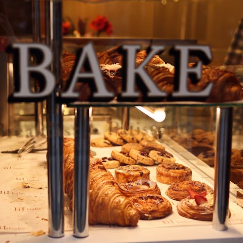 Free A display case with pastries and breads in it Stock Photo
