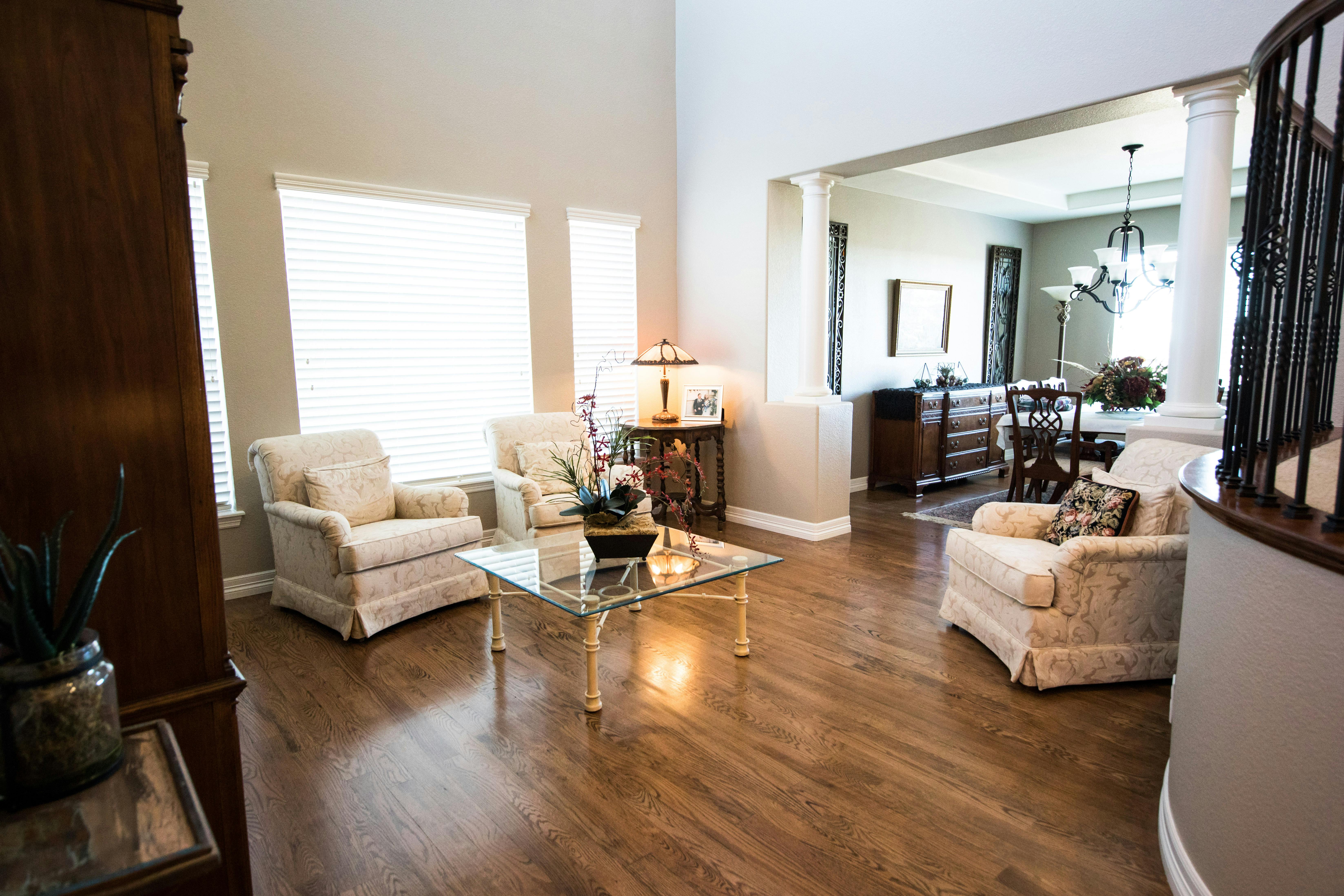 square clear glass top center table near gray padded armchair