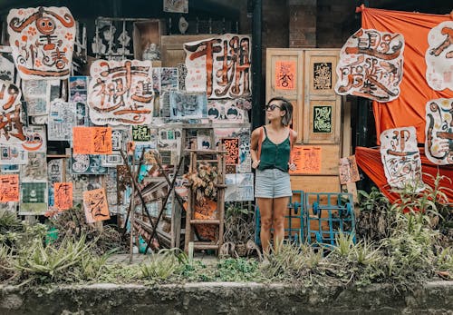 Woman Standing in Front of Paintings