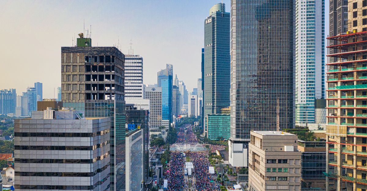 Skyline view of Jakarta with skyscrapers and bustling streets.